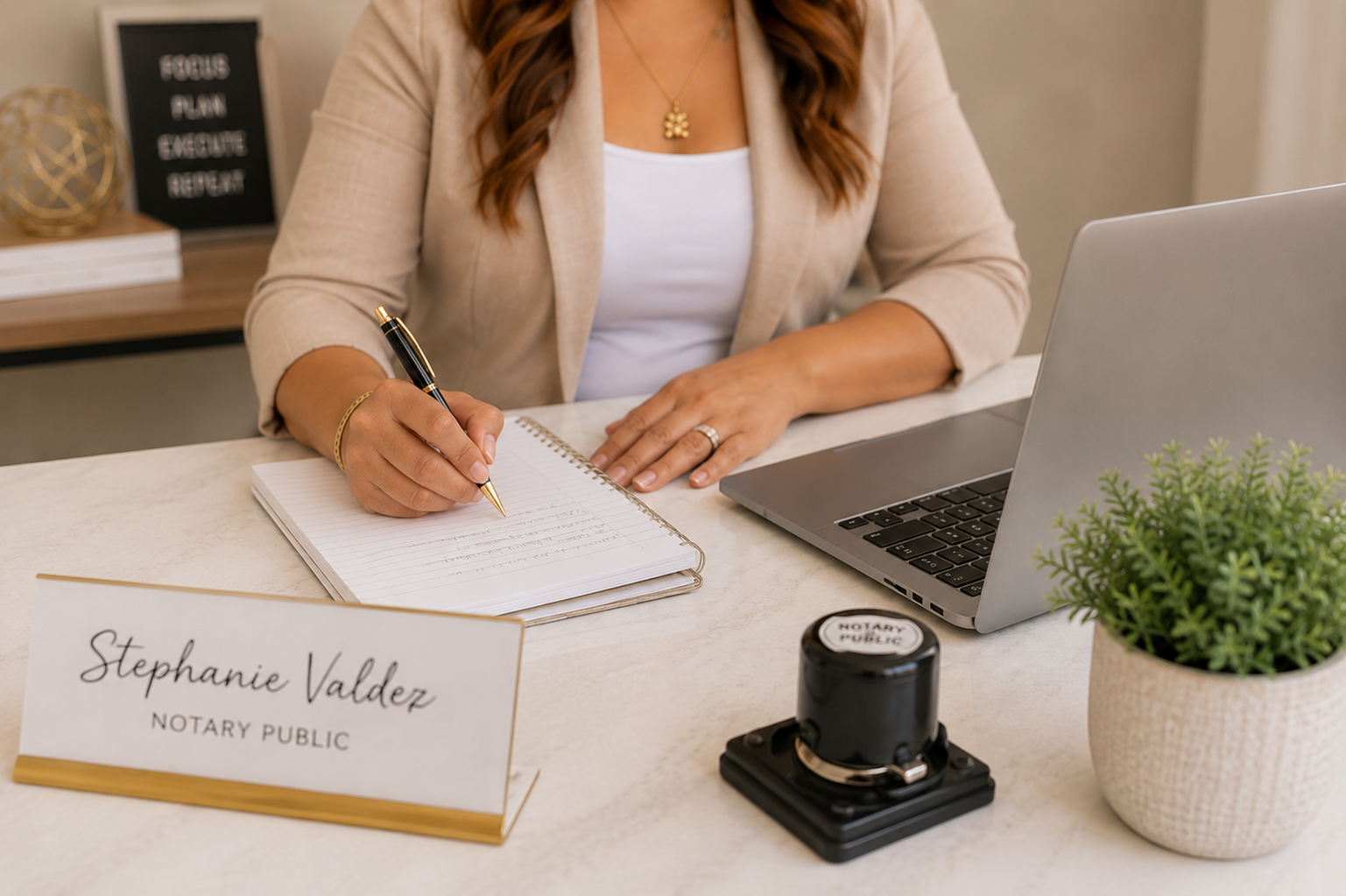 Notary desk with journal, notary stamp, and laptop
